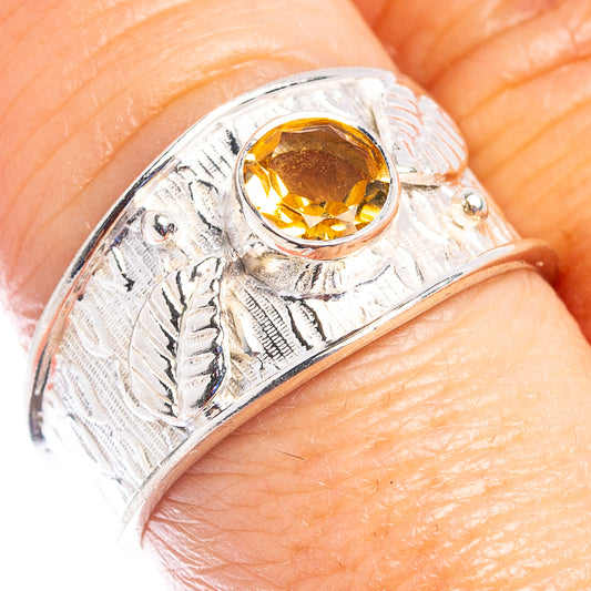Sterling silver ring with round citrine gemstone and engraved leaf pattern on band