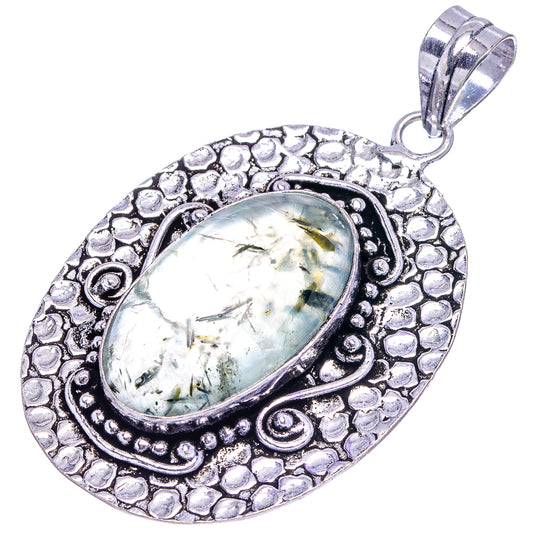 German silver oval pendant with pale green prehnite cabochon, ornate textured frame and bail