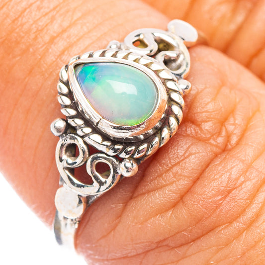Sterling silver opal ring with oval gemstone setting on finger