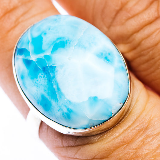Oval larimar stone ring in .925 sterling silver bezel, blue marbled oval on finger