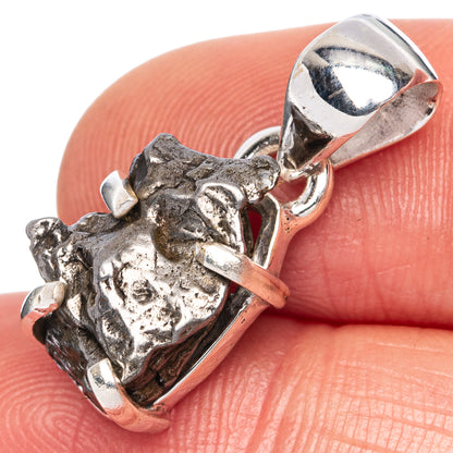 Sterling silver meteorite pendant close-up with dark textured center and bail