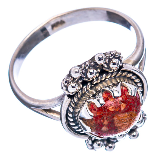 Sterling silver sponge coral ring, side view; red oval cabochon with carved floral settings