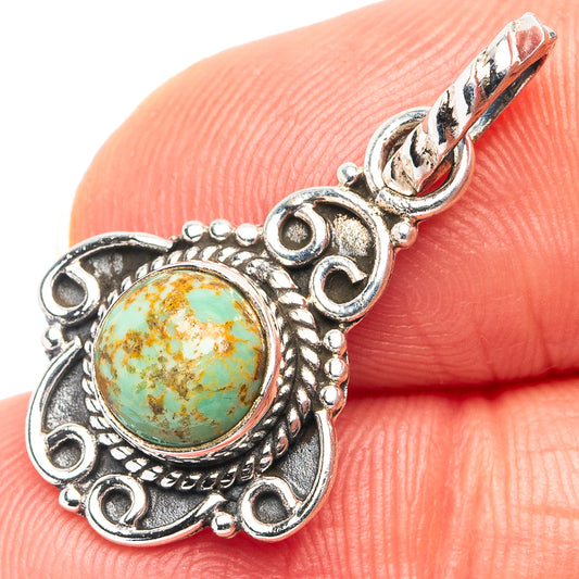 Round turquoise cabochon pendant in filigree-style sterling silver setting