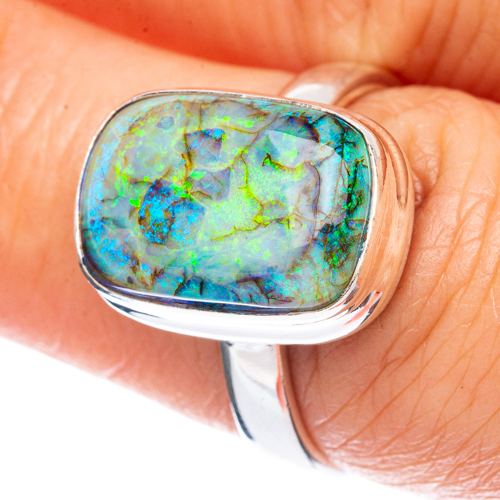 Oval opal gemstone sterling silver ring with iridescent blue-green pattern
