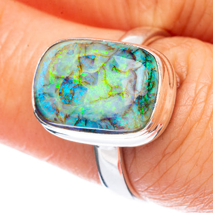 Oval opal gemstone sterling silver ring with iridescent blue-green pattern
