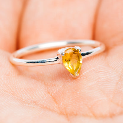 Sterling silver stackable ring with pear-cut yellow citrine stone, curved open band