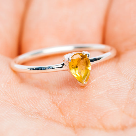 Sterling silver stackable ring with pear-cut yellow citrine stone, curved open band