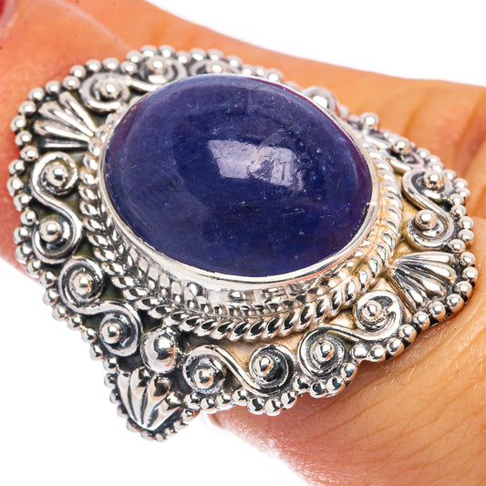 Sterling silver ring with oval blue-violet gemstone and ornate filigree setting