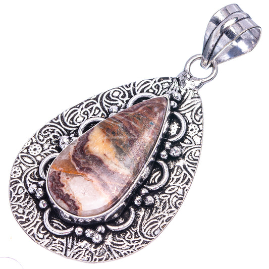 Antique silver-tone teardrop opal pendant with ornate filigree and small loop bail