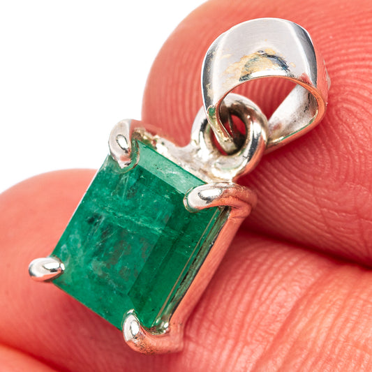 Sterling silver emerald pendant with rectangular green gemstone and side loops.