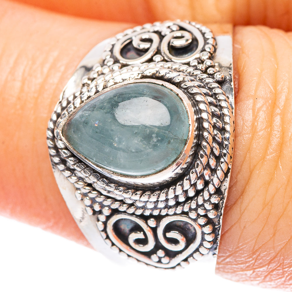 Sterling silver ring with oval aquamarine blue gemstone and ornate filigree bezel
