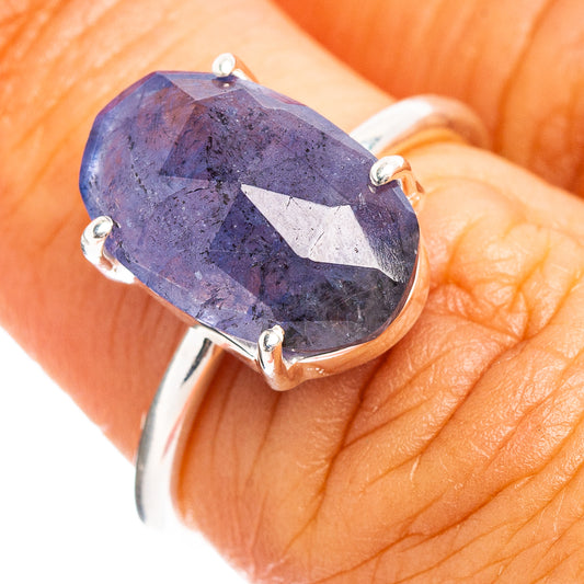 Sterling silver ring with faceted oval blue gemstone in four-prong setting