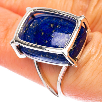 Lapis lazuli sterling silver ring on finger, rectangular blue cabochon in bezel