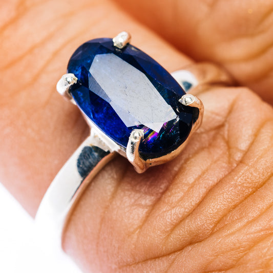 Sterling silver ring with faceted dark blue oval kyanite and four small stone settings