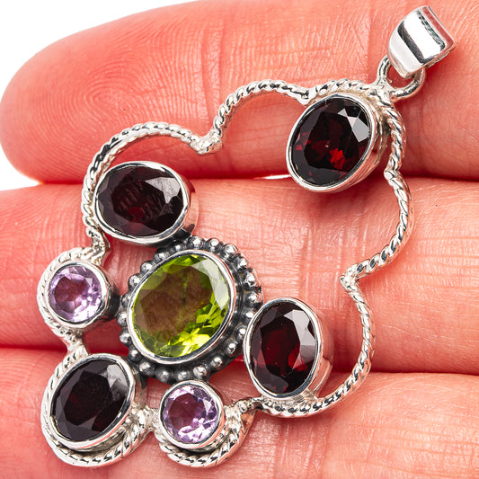 Sterling silver heart pendant with green peridot, purple amethyst, and red garnet stones