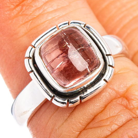 Sterling silver ring with oval pink gemstone bezel, hinged prongs