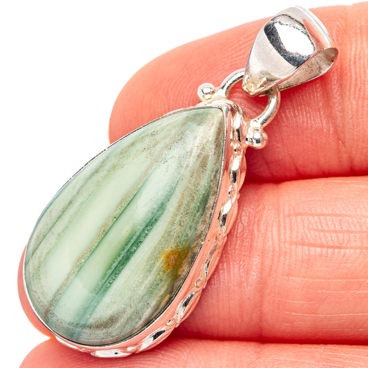 Sterling silver pendant with oval green stone and loop bail, polished scalloped bezel