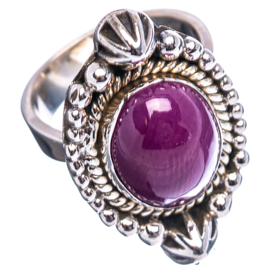 Sterling silver star ruby ring with oval purple cabochon, bead halo, and swirl details