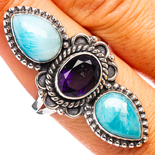 Sterling silver ring with two oval blue cabochons and a round purple gemstone center