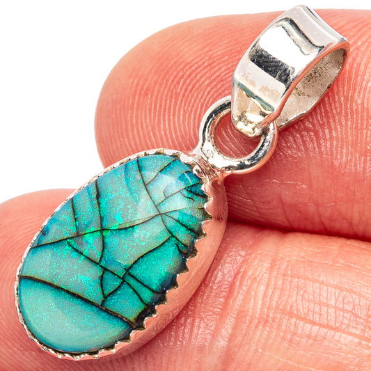Turquoise opal teardrop pendant close-up on silver bail with textured edge