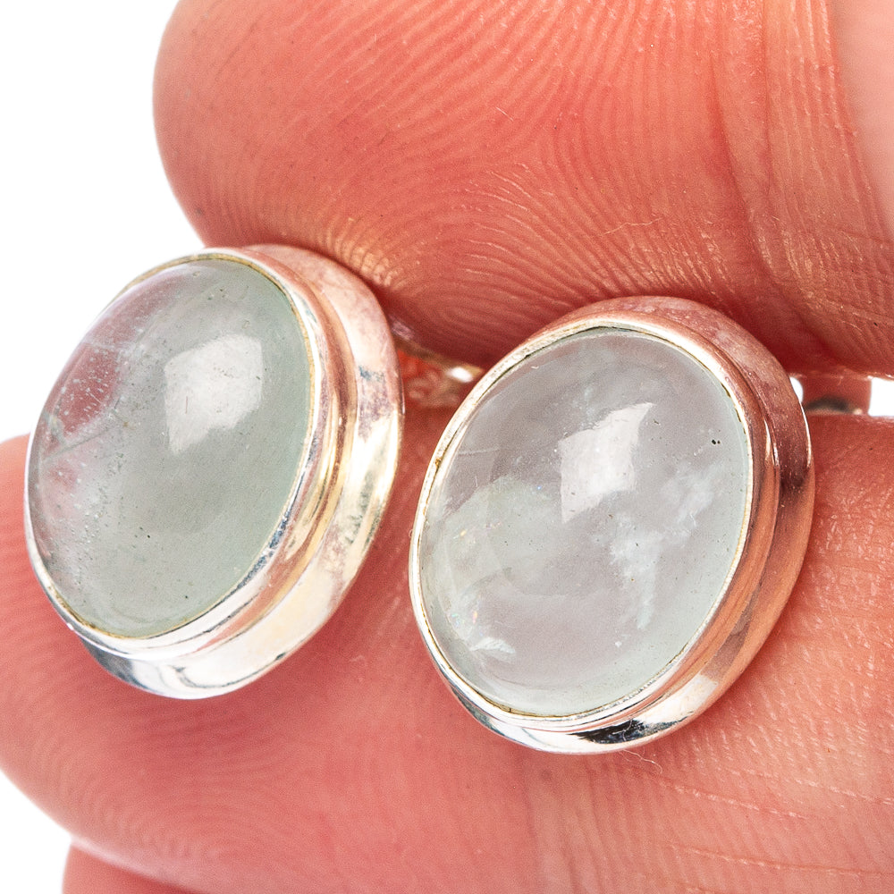 Oval sterling silver stud earrings with bezel-set pale aquamarine stones