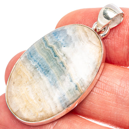 Blue scheelite oval pendant in 925 sterling silver bezel, close-up view
