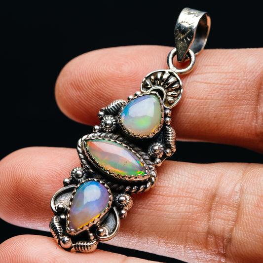 Sterling silver opal pendant with three oval Ethiopian opal cabochons, sculpted setting