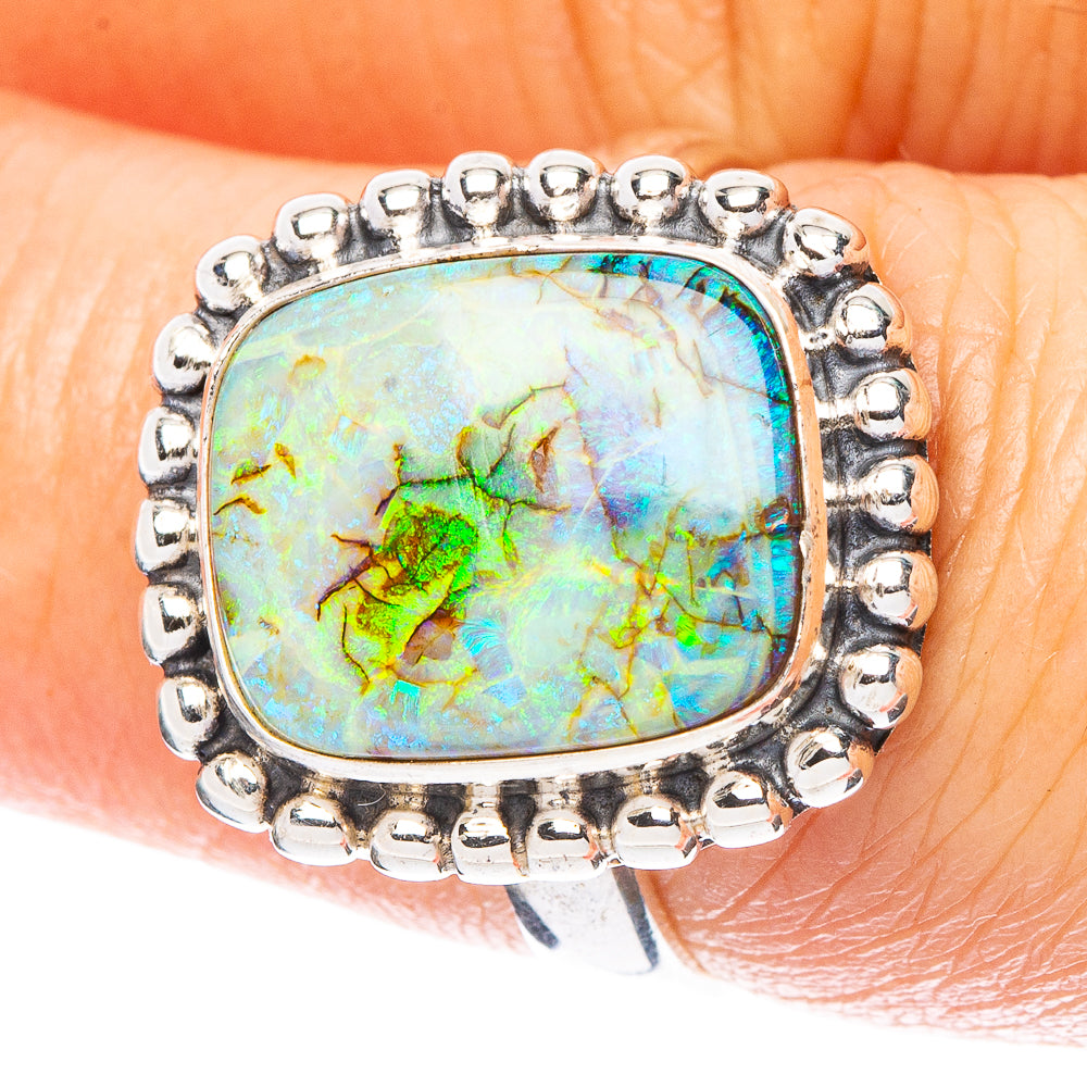 Oval opal set sterling silver ring with beaded bezel and prong details