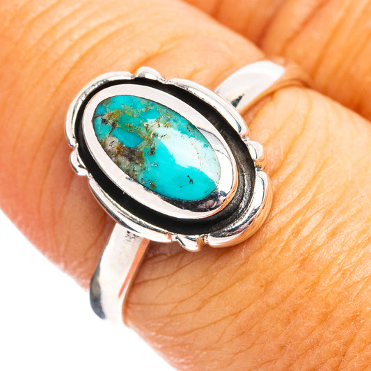 Oval turquoise cabochon sterling silver ring with double metal bezel and dark accents
