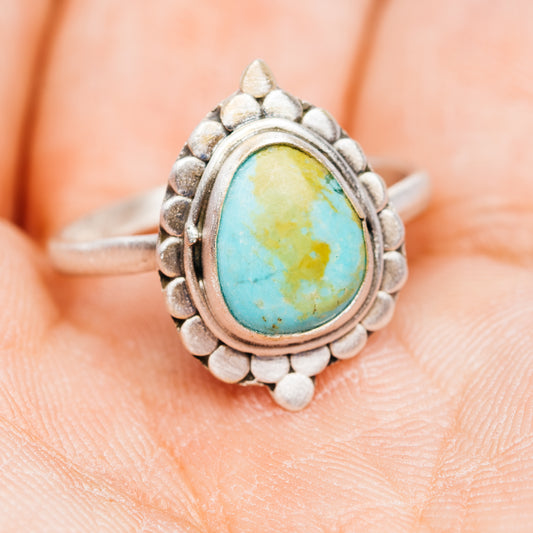 Turquoise oval sterling silver ring, textured border and side profile