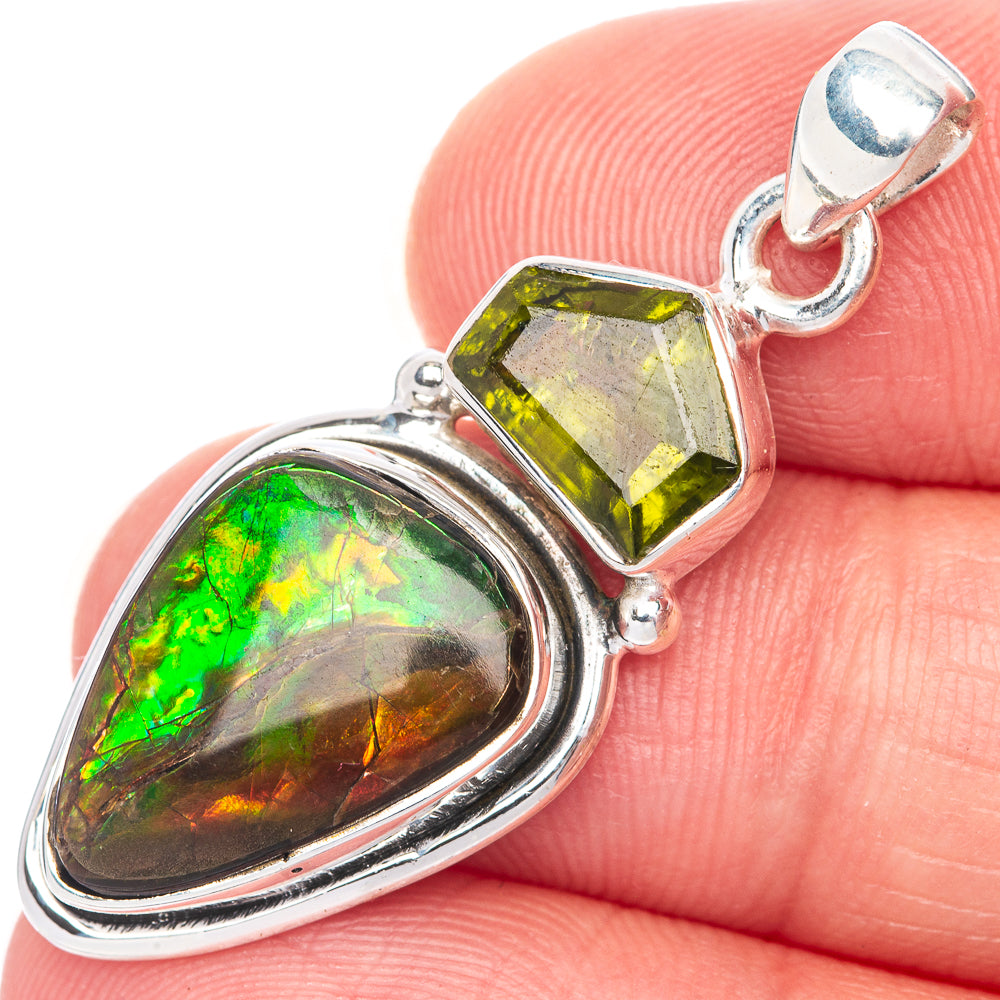 Sterling silver ammolite pendant close-up, oval iridescent stone with faceted green gem