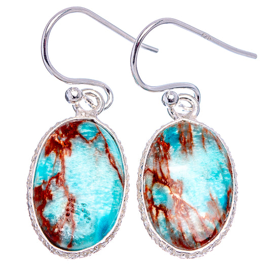 Sterling silver dangle earrings featuring oval blue imperial jasper with textured bezel, hooks.