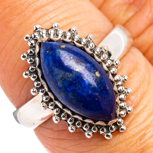 Lapis lazuli gemstone ring with blue teardrop stone and silver bead halo setting