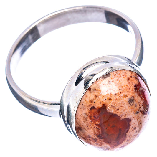 Sterling silver ring with oval fire opal cabochon in a polished bezel, wide band
