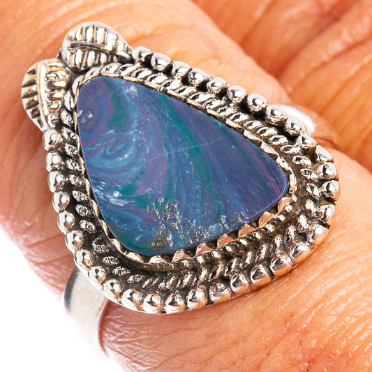Sterling silver opal doublet ring on hand, oval blue cabochon with textured bezel