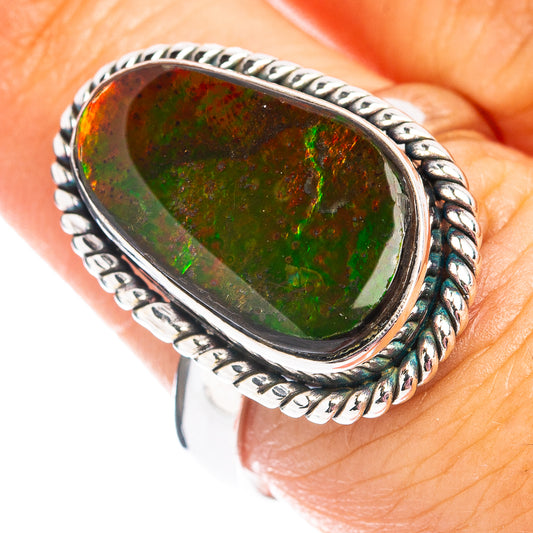 Sterling silver ammolite ring with oval green stone, braided bezel and rope band