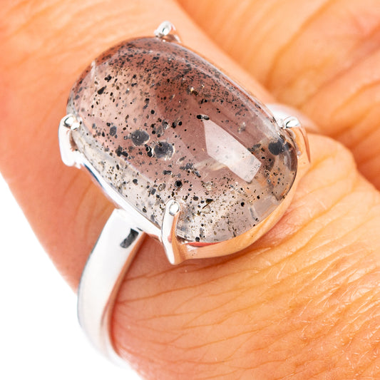 Sterling silver ring with oval rutilated quartz cabochon, side view on finger