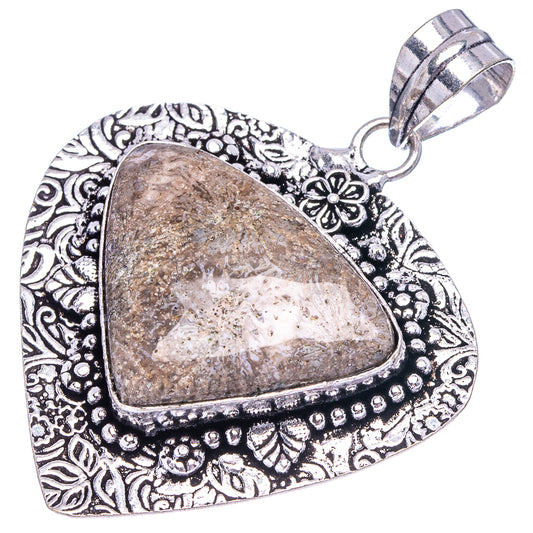 German silver teardrop pendant with mottled beige-brown stone and decorative border