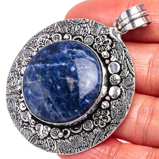 German silver sodalite pendant with round blue stone in ornate filigree setting