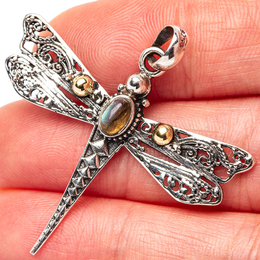 Sterling silver dragonfly pendant with oval iridescent stone and red enamel accents.