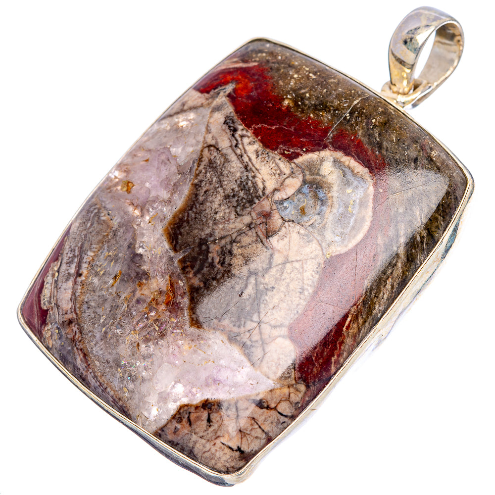 Sterling silver pendant with mottled rhyolite stone, rectangular bezel and bail loop