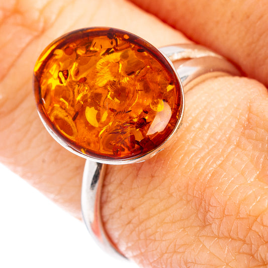 Adjustable .925 sterling silver ring with round amber cabochon bezel setting