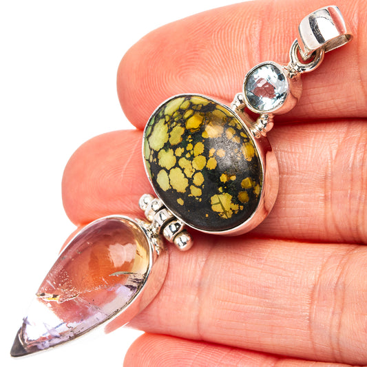 Sterling silver pendant with oval black-and-gold gemstone, purple drop, and blue top stone