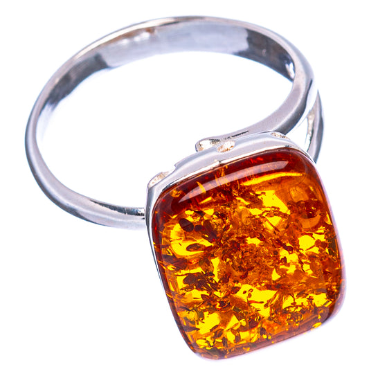 Sterling silver ring with oval amber cabochon bezel and open metal profile.