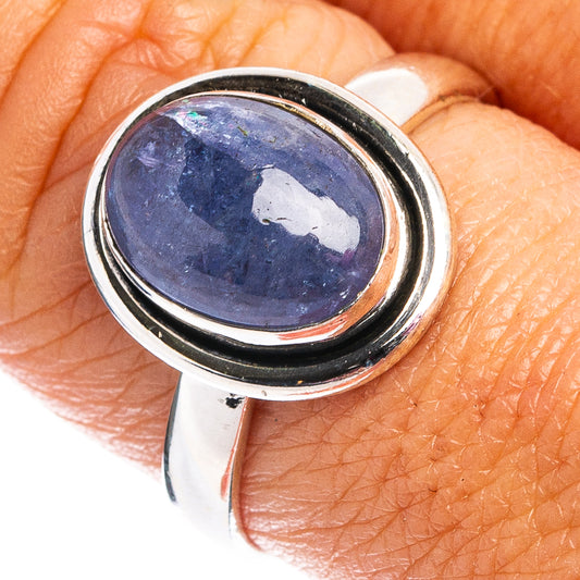 Sterling silver tanzanite ring with oval blue gemstone cabochon in bezel setting
