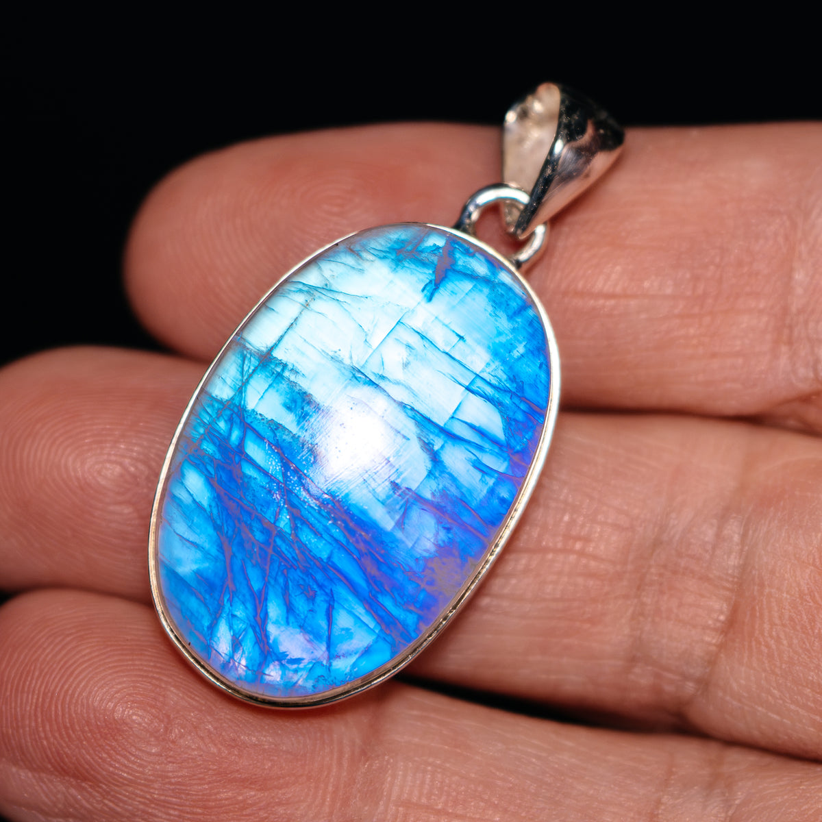 Oval rainbow moonstone pendant with blue cabochon in .925 sterling silver bezel