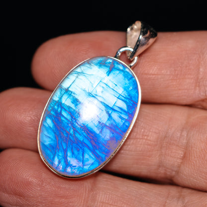 Oval rainbow moonstone pendant with blue cabochon in .925 sterling silver bezel