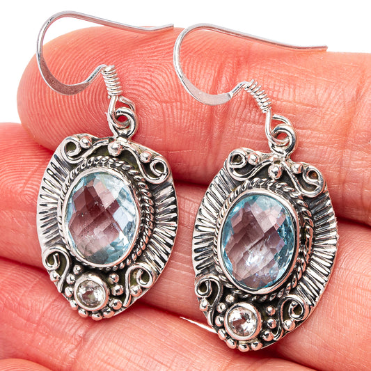 Sterling silver blue topaz drop earrings with oval gemstone and round clear accents