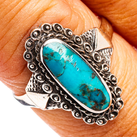 Turquoise oval sterling silver ring with ornate engraved bezel and patterned band