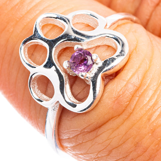 Sterling silver paw ring with round amethyst stone, shown on finger